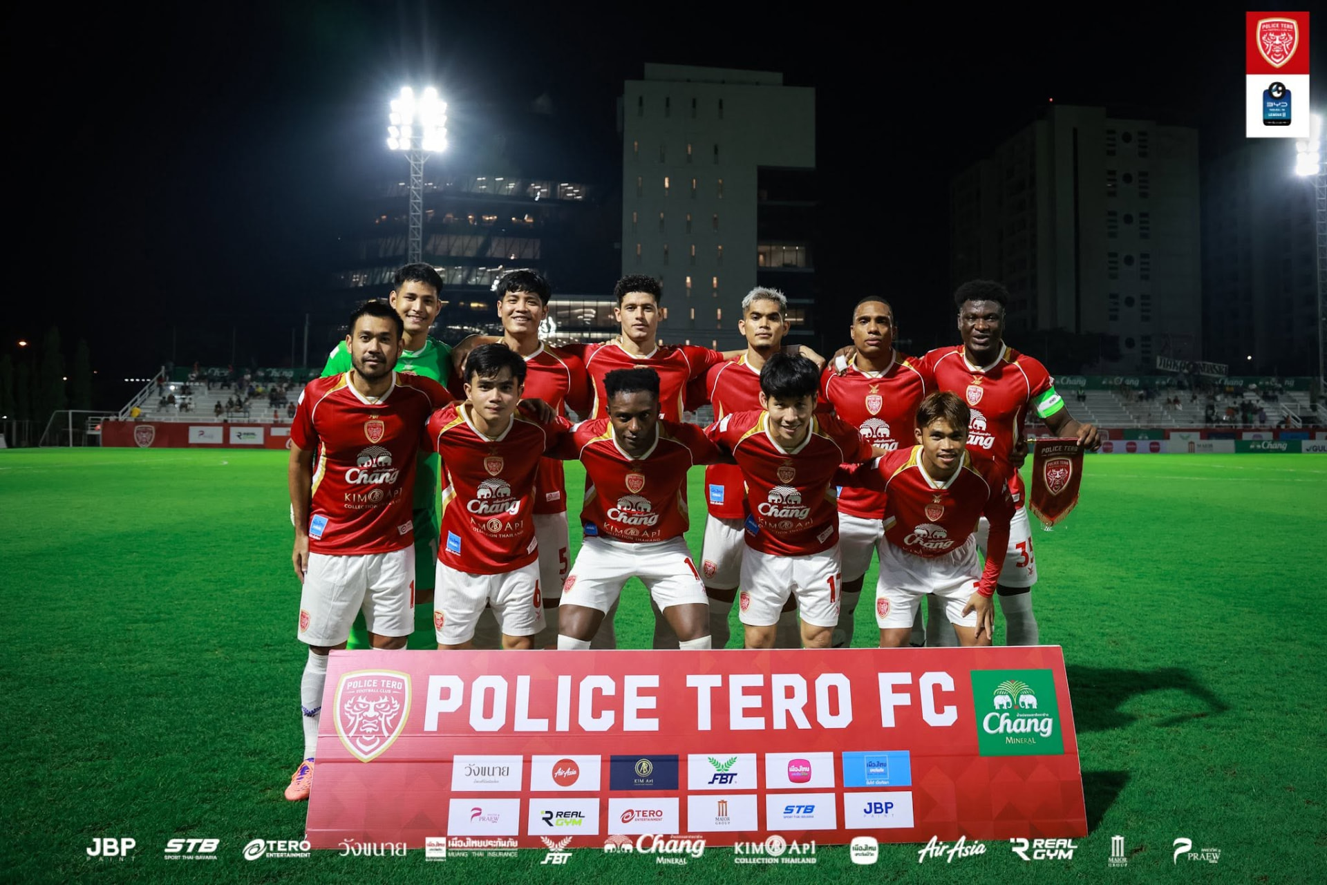 Police Tero FC starting eleven lined up under floodlights before kick-off